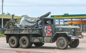 Cambodian soldiers stand on a military truck with an anti-aircraft gun in Oddar Meanchey province on July 26, 2025. Thailand and Cambodia clashed for a third day on July 26, as the death toll from their bloodiest fighting in years rose to 33 and Phnom Penh called for an "immediate ceasefire". (Photo by TANG CHHIN Sothy / AFP)
