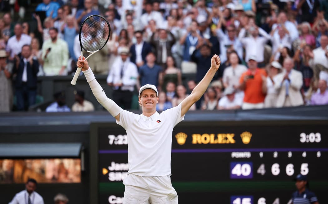 Italy's Jannik Sinner celebrates after victory against Spain's Carlos Alcaraz at the end of their men's singles final tennis match at Wimbledon, July 13, 2025. (Photo by HENRY NICHOLLS / AFP) / RESTRICTED TO EDITORIAL USE