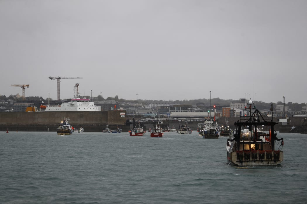 French fishing boats protest in front of the port of Saint Helier off the British island of Jersey to draw attention to what they see as unfair restrictions on their ability to fish in UK waters after Brexit, on May 6, 2021.