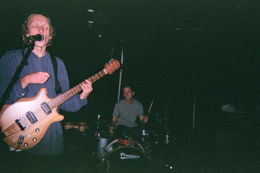 Lawrence Goodwin with his handmade guitar that was stolen from him (L-to-R Lawrence Goodwin,  Ollie Johnston)