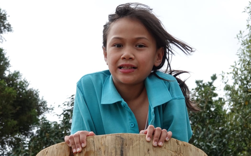Cortana, 7, is the first to the top of the climbing pole.