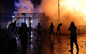 Protesters clash with Lebanese security forces on October 18, 2023, outside the US Embassy during a demonstration in solidarity with the people of Gaza in Awkar, East of Beirut, after a strike on a hospital in the Gaza Strip killed at least 200 people on October 17, 2023. The Israeli army said on October 17 a strike which hit a Gaza hospital, killing at least 200 people according to Hamas officials, was a rocket misfired by Palestinian militants. Lebanon's Iran-backed Hezbollah movement called for a "day of rage" to condemn the strike as hundreds of demonstrators gathered at the French and US embassies in protest. (Photo by JOSEPH EID / AFP)