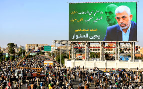 A billboard depicting Hamas' slain leader Yahya Sinwar with the Arabic slogan "if Sinwar departs from the battlefields, Palestine will birth a thousand Sinwars", during a rally in Yemen's Houthi-controlled capital Sanaa on October 18, 2024 in protest against Israel's attacks on Lebanon and the ongoing war between Israel and Hamas militants in the Gaza Strip. - Israel announced on October 17 the killing of Sinwar, mastermind of the October 7 attack, calling his death a "heavy blow" to the Palestinian group it has been fighting for more than a year. (Photo by Mohammed HUWAIS / AFP)