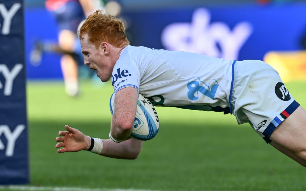 Finlay Christie dives to score a try for the Blues in his side's win over Moana Pasifika at Eden Park.