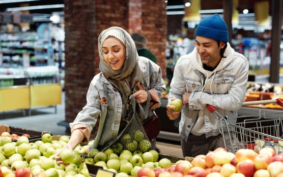 two people buying fruit in the supermarket