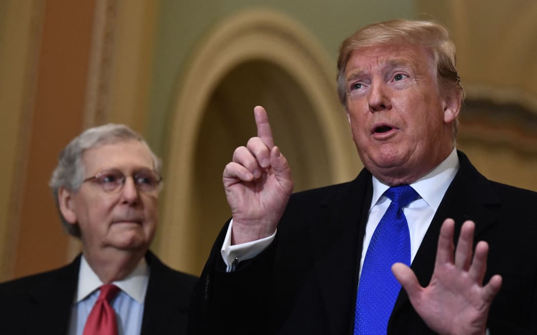 US President Donald Trump speaks to the press alongside Senate Majority Leader Mitch McConnell as he arrives on Capitol Hill on March 26, 2019 before joining Senate Republicans for lunch in Washington,DC. (Photo by Brendan Smialowski / AFP)