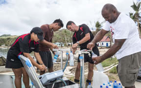 New Zealand army engineers help at a water desalination operation in Lomaloma village, Fiji after cyclone Winston.