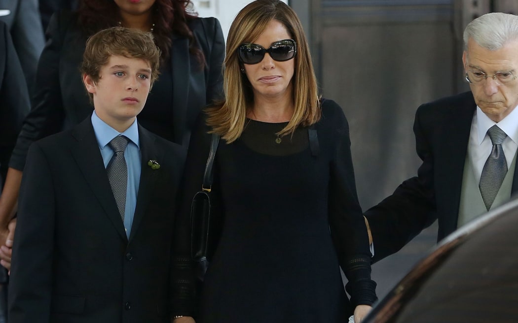 Melissa Rivers and her son Cooper Endicott leaving the service.