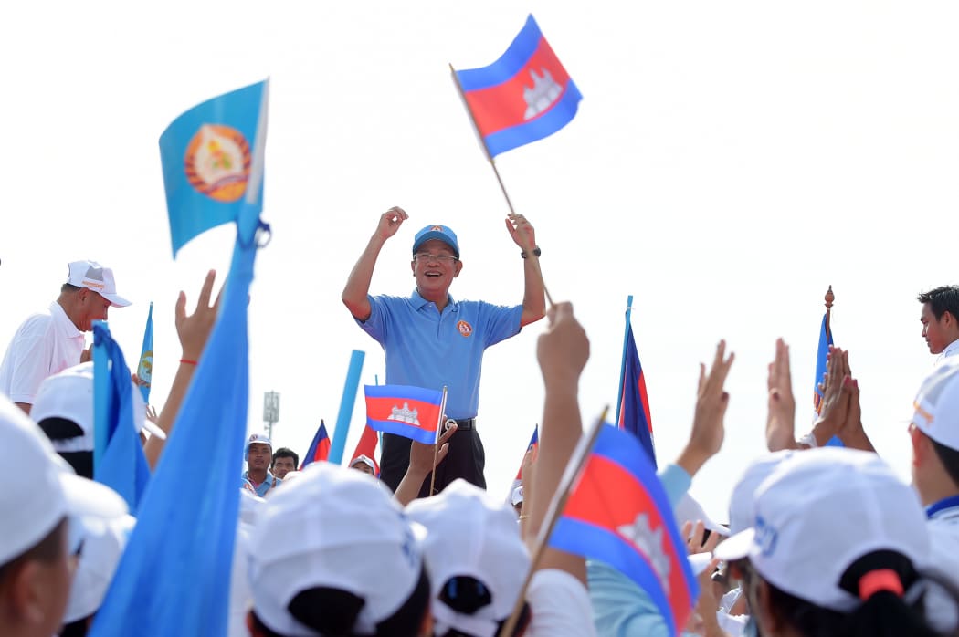 Cambodia's Prime Minister Hun Sen and leader of the ruling Cambodian People's Party (CPP) waves to supporters.