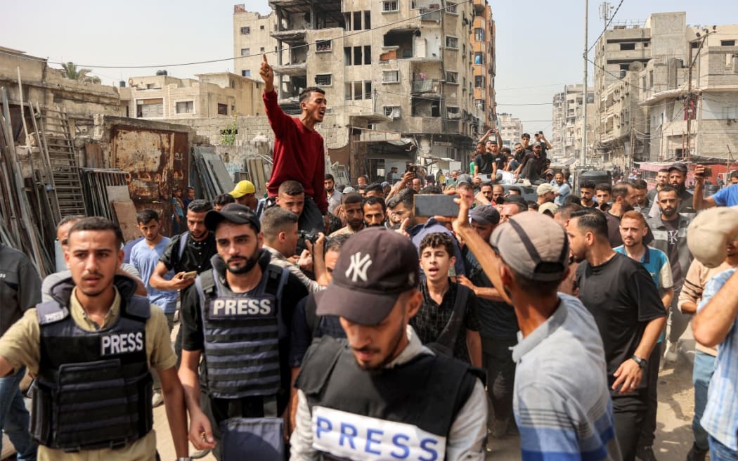 Mourners march with the bodies of the Al Jazeera journalists who were killed in an overnight Israeli strike on their tent in Gaza City, from Al-Shifa hospital to their burial at the Sheikh Radwan cemetery in Gaza City on August 11, 2025.