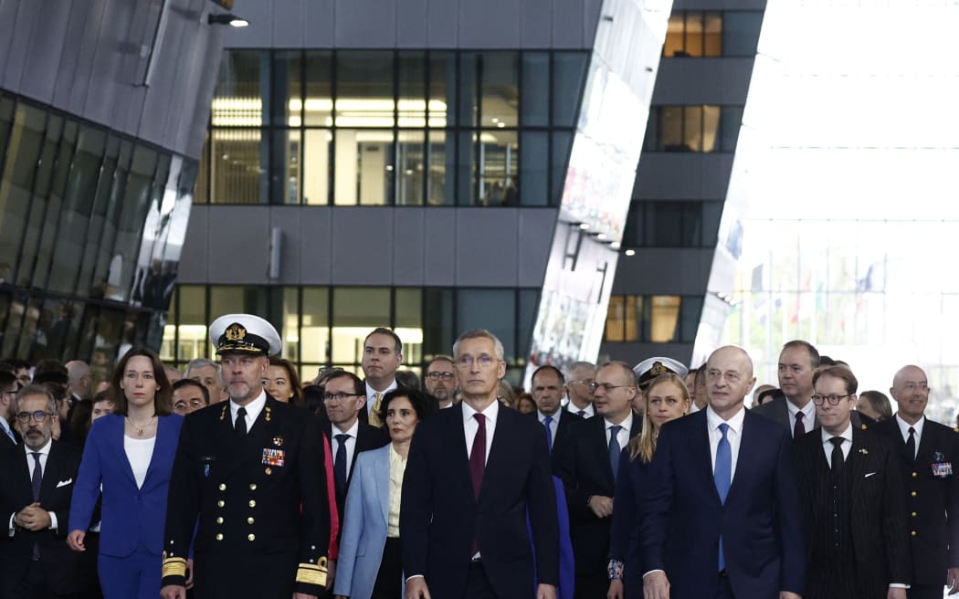 North Atlantic Treaty Organization (NATO) Secretary General Jens Stoltenberg (C) accompanied by the chair of the military committee of NATO Admiral Rob Bauer (front L), and NATO Deputy Secretary General Mircea Geoana (front R) and international foreign ministers attend the alliance's 75th anniversary at NATO Headquarters in Brussels on 4 April, 2024. The NATO military alliance on April 4, 2024, marks the 75th anniversary of the signing of its founding treaty in Washington.