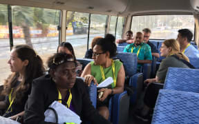 International and local journalists on a bus back to town after Chinese officials denied them permission to attend an APEC event featuring China's president.