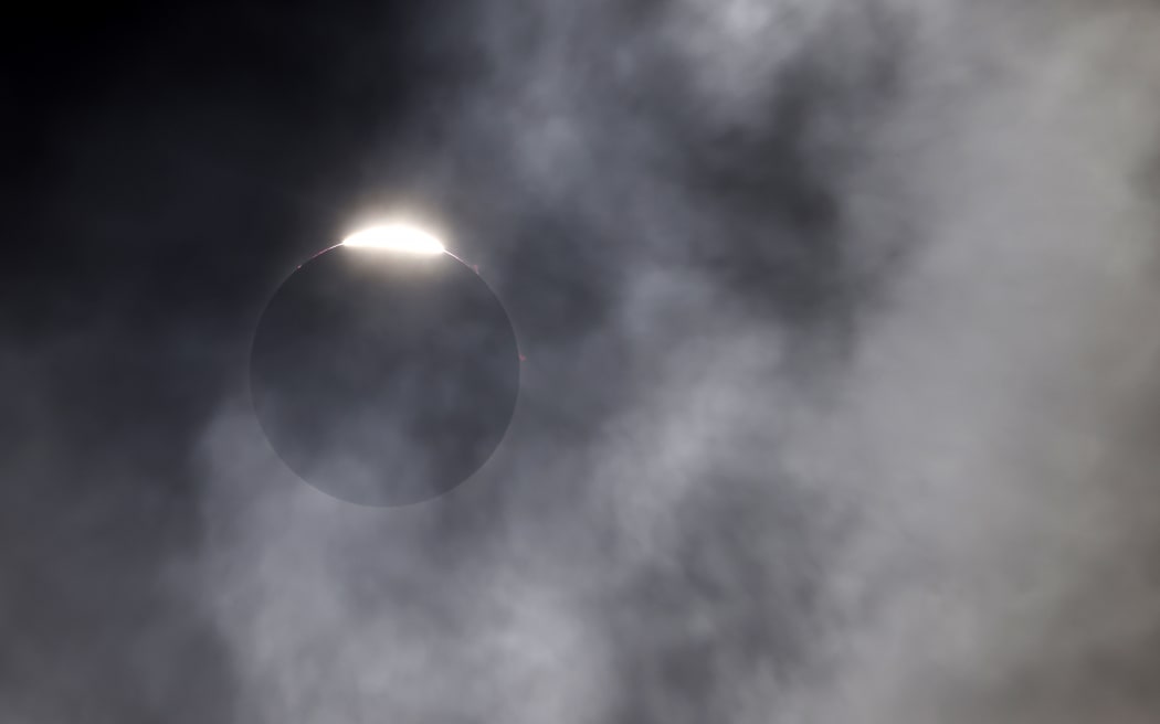 The diamond ring effect is seen as the moon eclipses the sun on April 8, 2024 in Fort Worth, Texas.