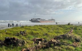 A Westland Mineral Sands barge Manahau lies grounded on Carters Beach, near Westport, on 1 September 2024.