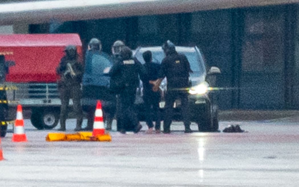 A man at the centre of a hostage standoff at Hamburg Airport was arrested and led away by police.