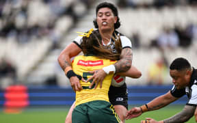 Gayle Broughton of New Zealand tackles Jakiya Whitfeld of Australia.