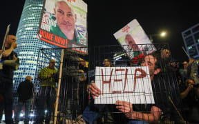 Relatives and supporters of Israeli hostages held in Gaza since the October 7 attacks by Hamas militants, hold placards during a demonstration in Tel Aviv, on March 26, 2024, amid the ongoing conflict in the Gaza Strip between Israel and the Palestinian militant Hamas movement. (Photo by JACK GUEZ / AFP)