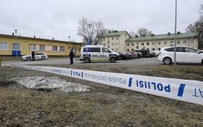Finnish police officers guard the scene behind police tapes at the primary Viertola comprehensive school where a child opened fire and injured three other children, on April 2, 2024 in Vantaa, outside the Finnish capital Helsinki. Police said, that the attacker was in custody, and "All those involved in the shooting incident are minors". (Photo by Markku Ulander / Lehtikuva / AFP) / Finland OUT
