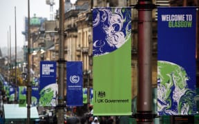COP26 banners hang from lamp posts in Glasgow on October 29, 2021 ahead of the start of the climate summit. (Photo by Andy Buchanan / AFP)