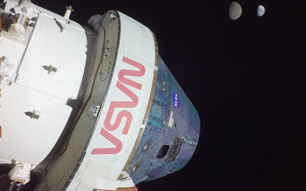Nasa's Orion spacecraft with the moon and Earth in the background