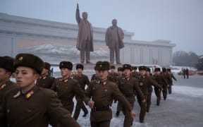 Korean People's Army soldiers leave after bowing before the statues of late North Korean leaders Kim Il Sung and Kim Jong Il during National Memorial Day in Pyongyang on 17 December, 2018.