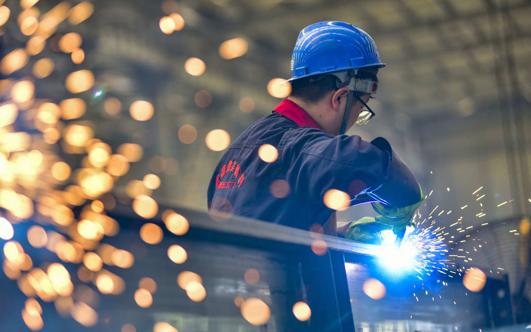QINGZHOU, CHINA - AUGUST 27, 2023 - A worker welds at a temperature control equipment manufacturing enterprise in Qingzhou Economic Development Zone, East China's Shandong province, Aug. 27, 2023. On the same day, the National Bureau of Statistics released data, from January to July, the total profit of industrial enterprises above designated size in the country was 3,943.98 billion yuan, down 15.5% year-on-year, and the decline was 1.3 percentage points narrower than that in January to June. (Photo by Costfoto/NurPhoto) (Photo by CFOTO / NurPhoto / NurPhoto via AFP)