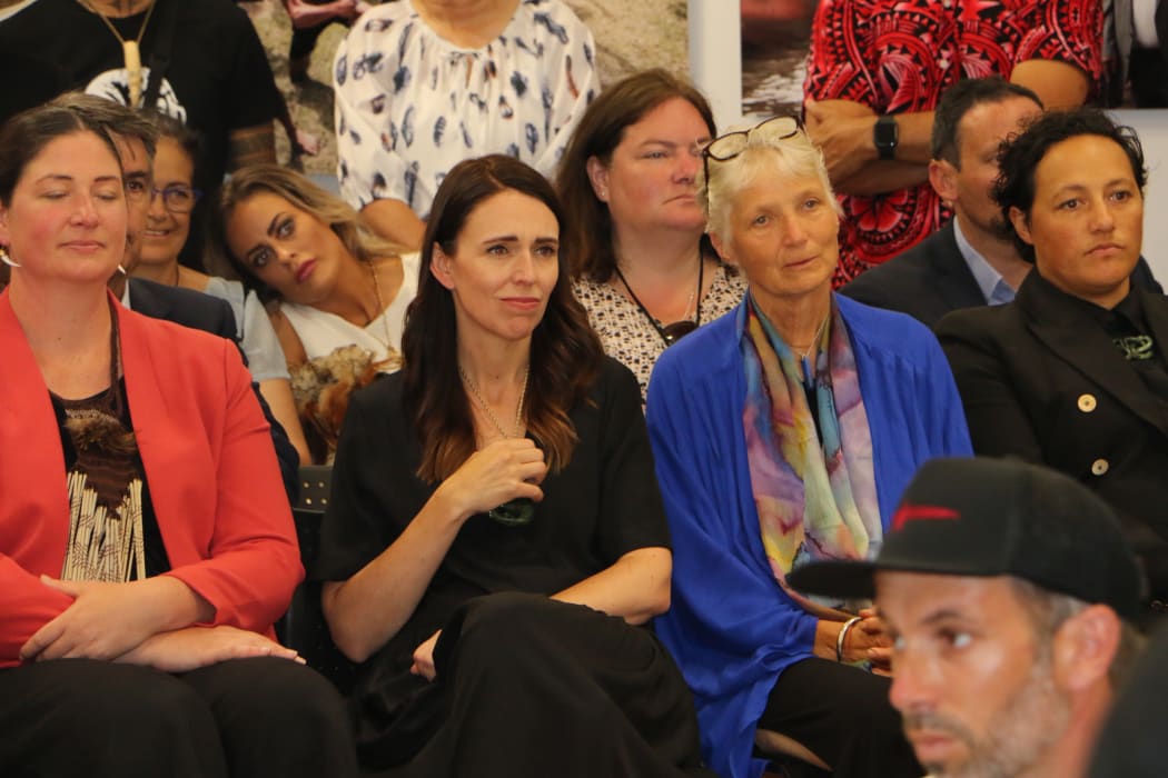 The Prime Minister Jacinda Ardern sits in the crowd at the He Kaupapa Waka exhibition.