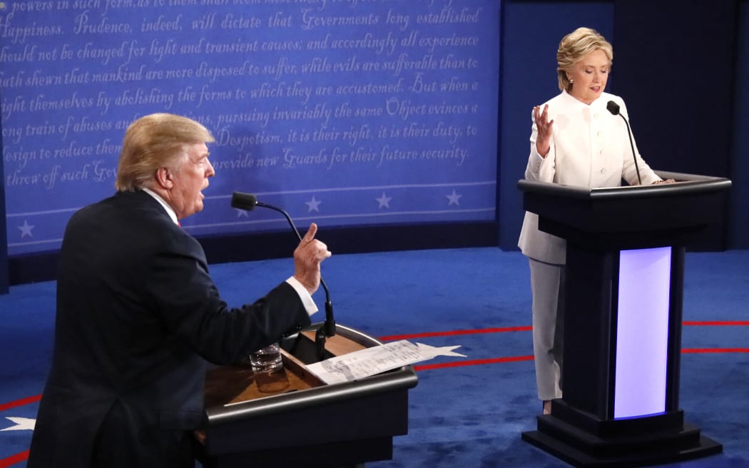 Republican nominee Donald Trump and Democratic nominee Hillary Clinton speak during the final presidential debate at the Thomas & Mack Center on the campus of the University of Las Vegas in Las Vegas, Nevada on October 19, 2016. (Photo by Mark  RALSTON / AFP)