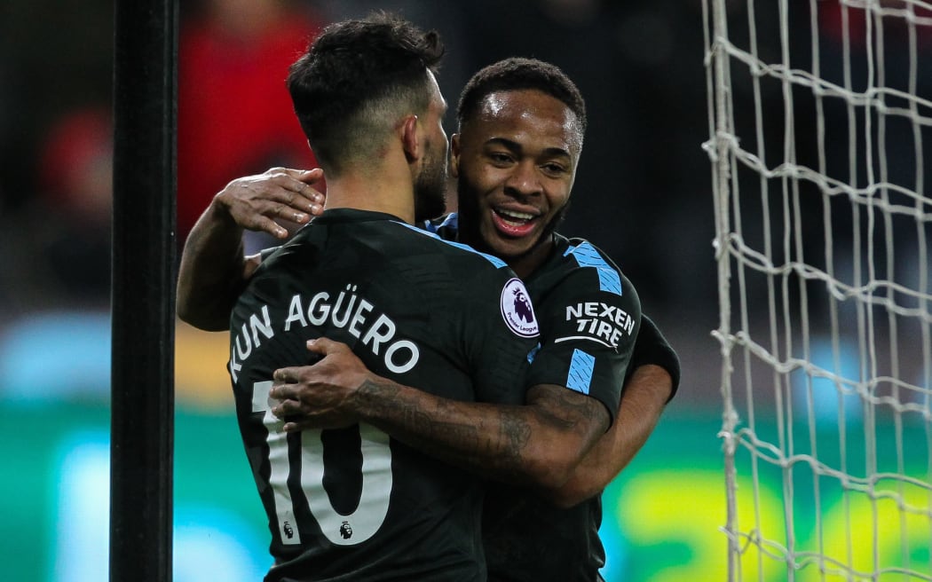 Manchester City stars Sergio Aguero, left, and Raheem Sterling celebrate a goal.