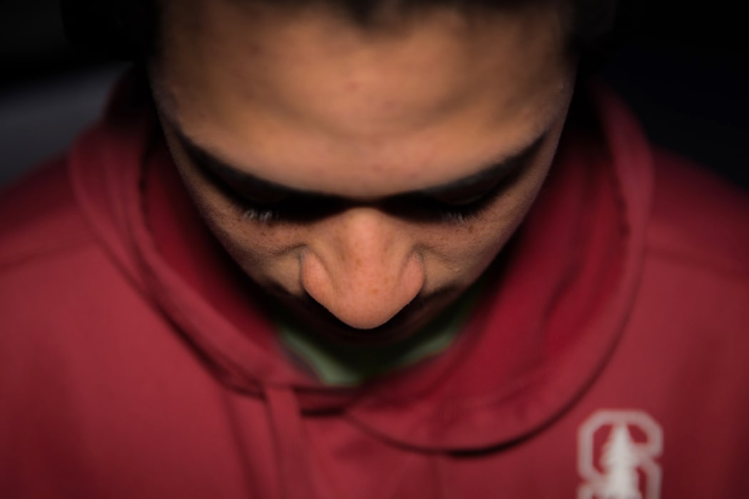 A teenage Māori boy looking unhappy