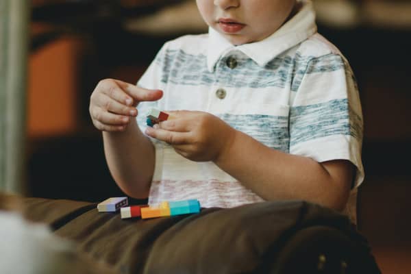 Child playing with brick toys.