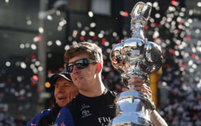 Peter Burling with cup and ticker tape in Wellington
