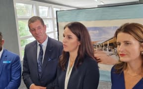 Erica Stanford, flanked by government colleagues Mike Butterick and Nicola Willis, announces the new specialist schools.