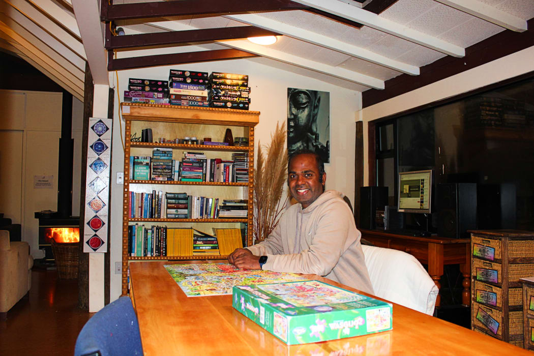 Ajay Agrahari, 37, sits at the puzzle table in Rangi, the residents' lounge.