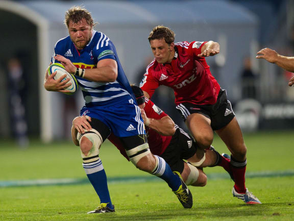 The Stormers' Daniel Vermeulen tackled by Matt Todd (back) and Tom Taylor of the Crusaders.