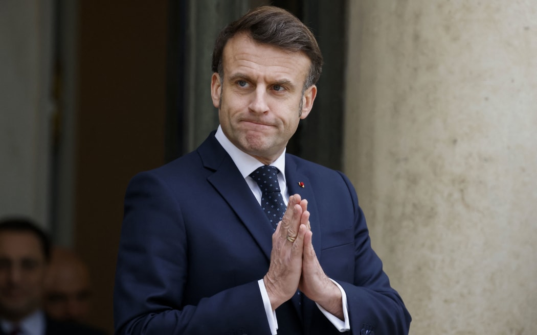 France's President Emmanuel Macron gestures as he waits for Romania's interim President for talks at the Elysee presidential Palace in Paris on February 19, 2025, one day after a meeting with seven European countries, focused on Ukraine, in the belief that ‘Russia is an existential threat’ to the continent. After bringing together the heavyweights of the European Union, Emmanuel Macron will have spoken to the 27 Member States by the end of the week. (Photo by Ludovic MARIN / AFP)