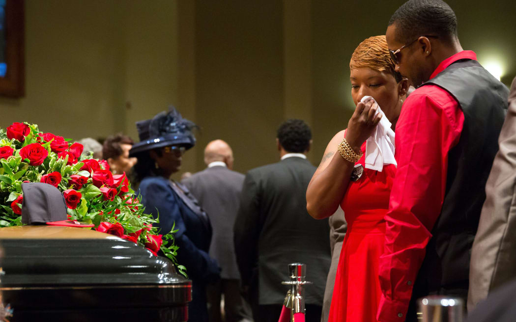 Lesley McSpadden stands before the casket of her son, Michael Brown.