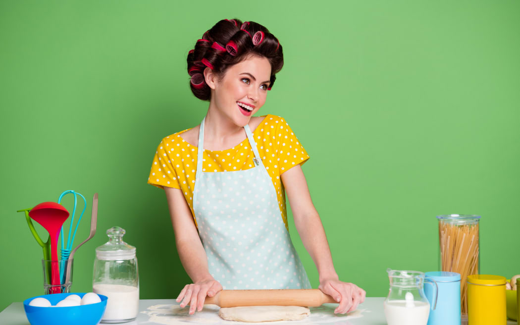 Portrait of her she nice attractive lovely glamorous cheerful housewife, cooking delicious pizza rolling dough enjoying weekend hobby workshop isolated over green pastel color background