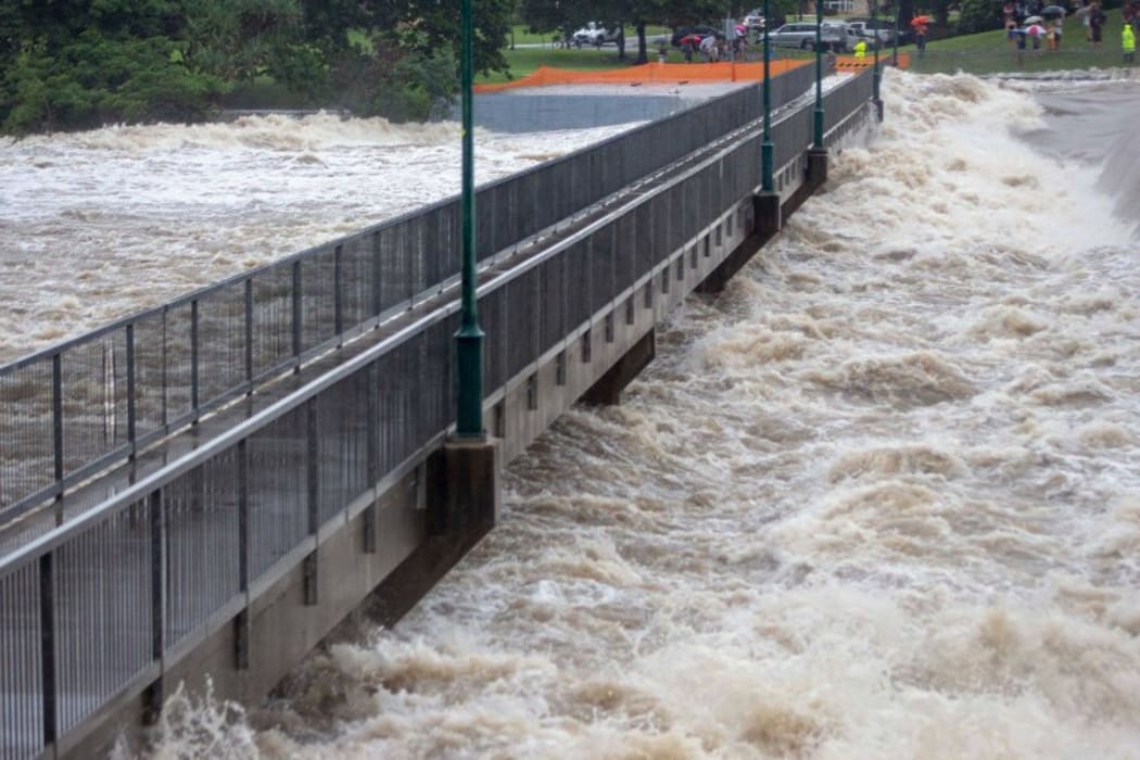 This recent undated handout picture provided by the Queensland Fire and Emergency Services and received by AFP on February 3, 2019 shows floodwaters as they rush over the Aplins Weir in Townsville after days of torrential rain.