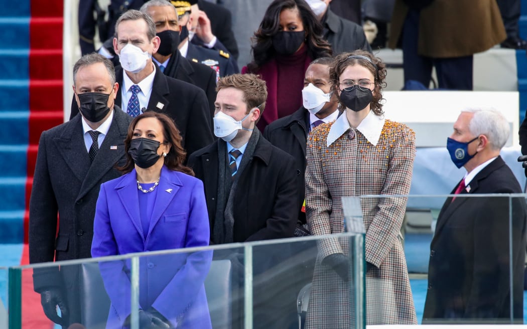 WASHINGTON, DC - JANUARY 20: Doug Emhoff (from left), Vice President Elect Kamala Harris, Cole Emhoff, Ella Emhoff, and Vice President Mike Pence stand as Lady Gaga sings the National Anthem at the inauguration of U.S. President-elect Joe Biden on the West Front of the U.S. Capitol on January 20, 2021 in Washington, DC. During today's inauguration ceremony Joe Biden becomes the 46th president of the United States.   Win McNamee/Getty Images/AFP (Photo by Rob Carr / GETTY IMAGES NORTH AMERICA / Getty Images via AFP)