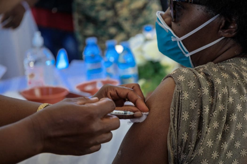 An Ugandan doctor receives the first injection of the Oxford AstraZeneca Covid-19 vaccine at Mulago referral hospital in Kampala,