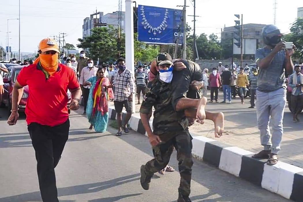 Rescuers evacuate people following a gas leak incident at an LG Polymers plant in Visakhapatnam on May 7, 2020.