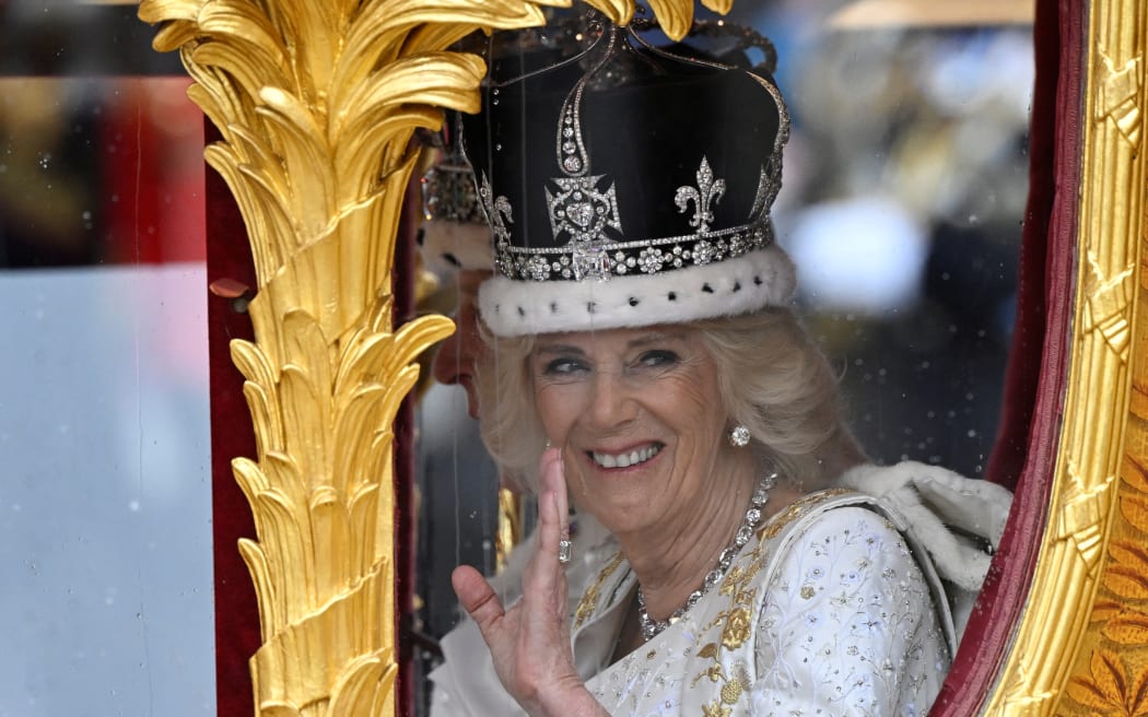 Britain's King Charles III wearing the Imperial state Crown, and Queen Camilla, wearing a modified version of Queen Mary's Crown leave Westminster Abbey after the Coronation Ceremonies in central London on May 6, 2023. - The set-piece coronation is the first in Britain in 70 years, and only the second in history to be televised. Charles will be the 40th reigning monarch to be crowned at the central London church since King William I in 1066. Outside the UK, he is also king of 14 other Commonwealth countries, including Australia, Canada and New Zealand. (Photo by TOBY MELVILLE / POOL / AFP)