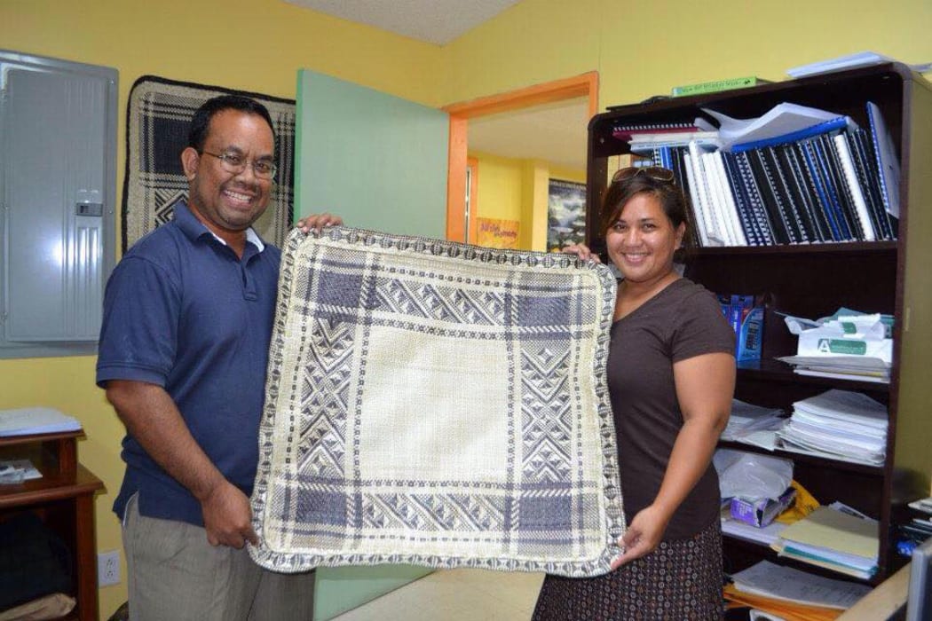 Mattlan Zackhras and his wife Angela show off a fine woven mat made by a youthful trainee from his home atoll of Namdrik in this file photo from 2013.
