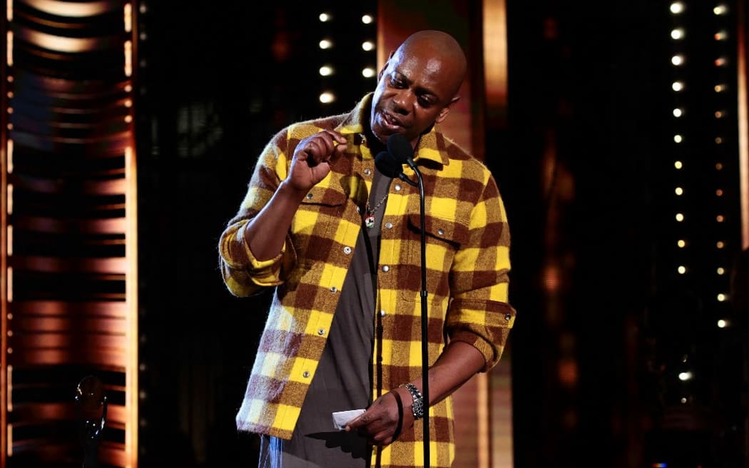 CLEVELAND, OHIO - OCTOBER 30: Dave Chappelle speaks onstage during the 36th Annual Rock & Roll Hall Of Fame Induction Ceremony at Rocket Mortgage Fieldhouse on October 30, 2021 in Cleveland, Ohio.   Dimitrios Kambouris/Getty Images for The Rock and Roll Hall of Fame /AFP (Photo by Dimitrios Kambouris / GETTY IMAGES NORTH AMERICA / Getty Images via AFP)