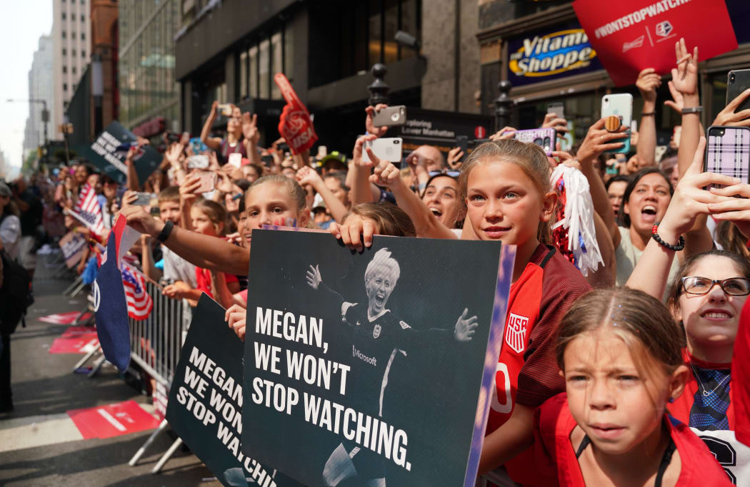 NEW YORK - JULY 10: People wave the players of the U.S Women's National Soccer team during a Victory Parade and City Hall Ceremony in New York, United States on July 10, 2019. The U.S. won the 2019 FIFA Women's World Cup