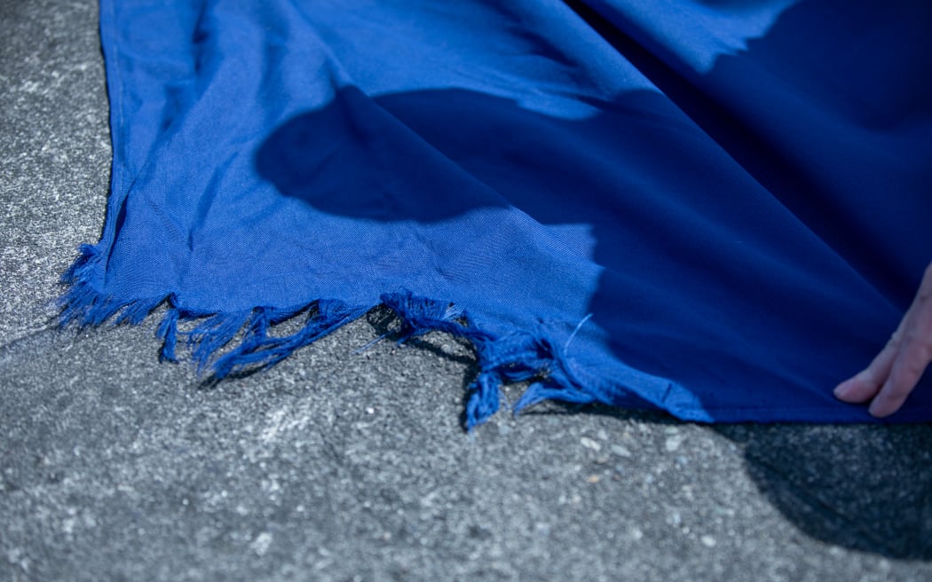 Wind damage to the leading edge of the Beehive's national flag.