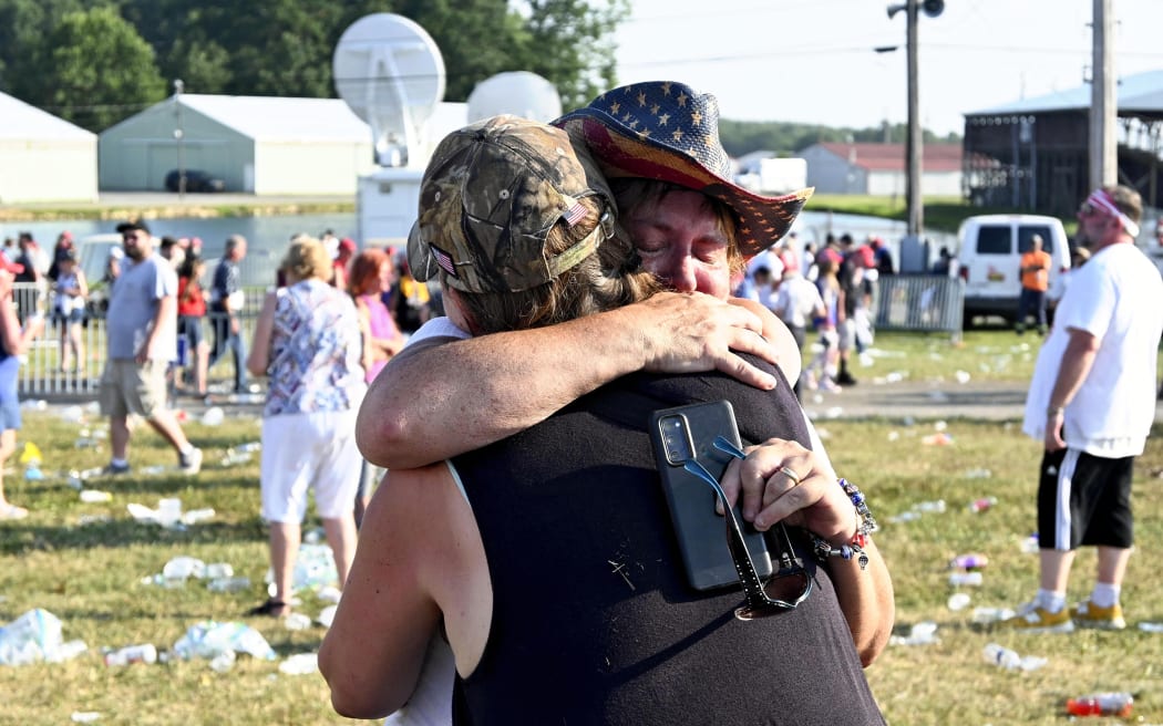 Supporters hug after US Republican presidential candidate Donald Trump was shot in Butler, Pennsylvania on 13 July, 2024.