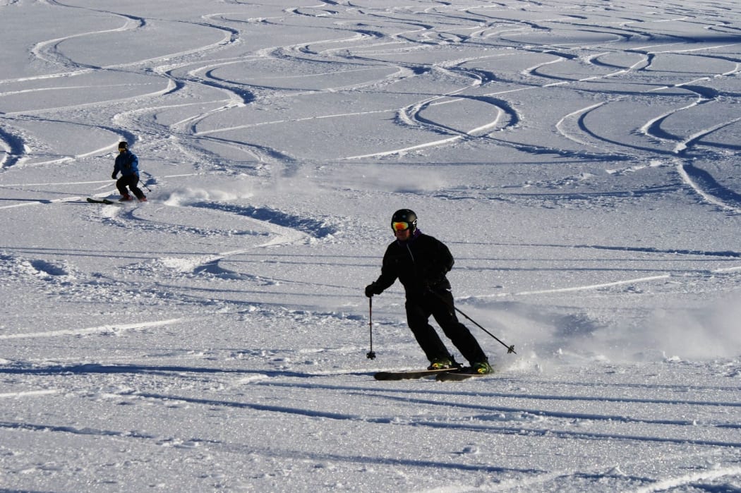 Skiers get in their first turns for the 2014 snow season at Mt Hutt.