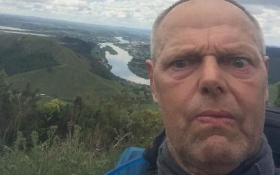 Bruce pulls a face as he poses in front of the Waikato river.